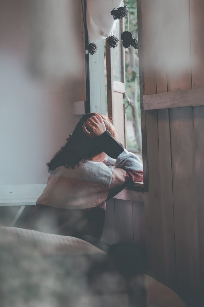 photo of a person leaning on wooden window 1510149